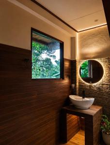 a bathroom with a sink and a window at THE JUNGLE CABIN ella in Ella +78 photos