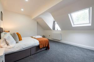 a attic bedroom with a bed and a window at Spacious 6BR Cardiff House w/ Free Parking in Cardiff