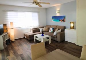 a living room with a couch and a table at Blue Sail Apartments in Simpson Bay