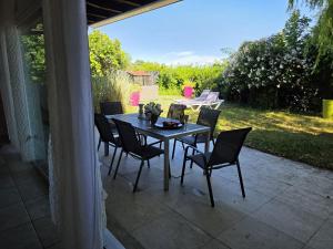 a table and chairs sitting on a patio at La parenthèse du lac in Bevaix