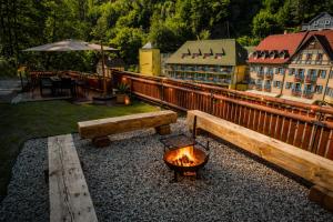 a fire pit with two benches and a grill at Chalupa 47 in Hřensko +51 photos