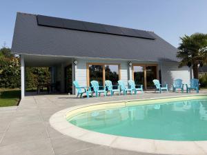 a patio with chairs and a swimming pool at Gîte Ker Koad in Pluduno