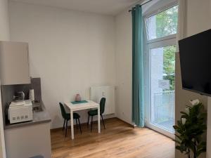 a small room with a table and chairs and a window at Felix Appartment H1a in Koblenz
