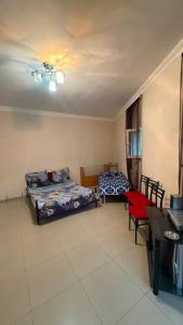 a living room with two beds and a table at Joni Mot in Goris