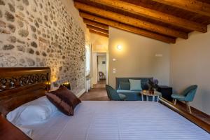a bedroom with a bed and a living room at Relais Corte Baruzzo in Volta Mantovana +49 photos