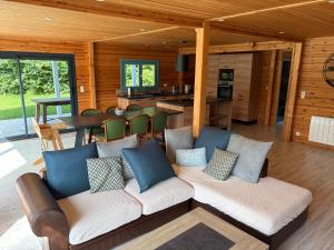 a living room with a couch and a table at Gîte Ker Koad in Pluduno