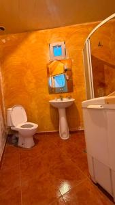 a bathroom with a toilet and a sink and a tub at Joni Mot in Goris