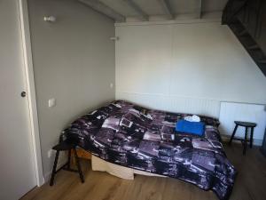 a bedroom with a bed with a purple comforter at Refuge de l'Ecureuil in Métabief