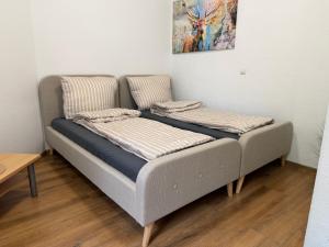 a couch with pillows on it in a room at Felix Appartment H1a in Koblenz