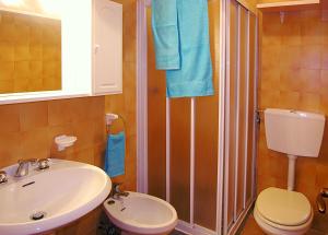 a bathroom with a sink and a toilet and a shower at Appartamenti Nasse in Bibione