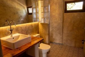 a bathroom with a sink and a toilet at Goodmuda in Grândola +64 photos