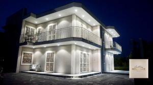 a large white building with a balcony on top of it at CasaMamy Residence in Pompei