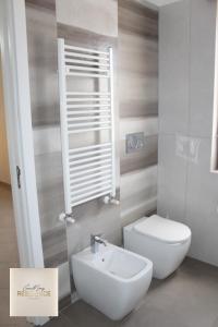 a bathroom with a white toilet and a sink at CasaMamy Residence in Pompei +98 photos