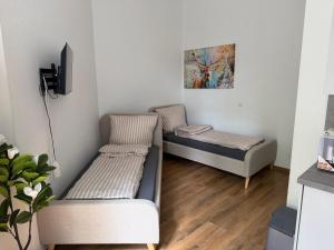 a living room with two beds and a tv at Felix Appartment H1a in Koblenz
