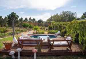 a backyard with a pool and a table and chairs at Goodmuda in Grândola