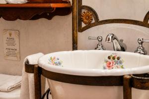 a sink with flowers painted on it in a bathroom at Casa Aliso Hotel Boutique in Quito +58 photos