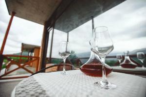 two wine glasses sitting on top of a table at Jvarisa cottages in Bugeuli