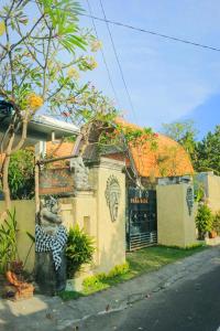 a building with a statue in front of it at The Box Paradise Bungalow in Nusa Penida
