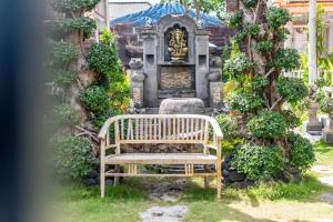 a wooden bench sitting in front of a cemetery at The Box Paradise Bungalow in Nusa Penida +15 photos