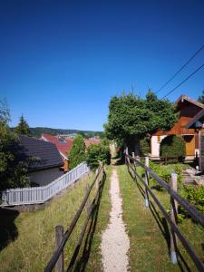 a dirt road next to a fence at Refuge de l'Ecureuil in Métabief