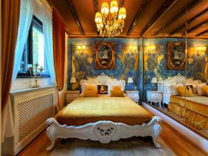 a bedroom with two beds and a chandelier at Conacul Coroanei Luxury Boutique in Bucharest