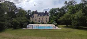 a large castle with a swimming pool in front of it at Château de Villechauvon in Vatan