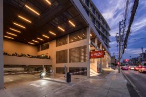 a building on the corner of a street at Prano Hotel in Bangkok