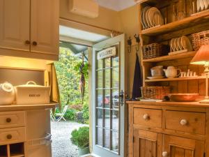 a kitchen with a door leading to a patio at Granary Cottage in Kirkby Malham