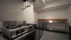 a kitchen with a stove top oven in a kitchen at 福渡邸 in Narita