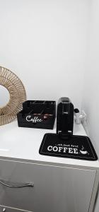 a counter with a coffee box on top at Sky Chalet in Ndërlysaj
