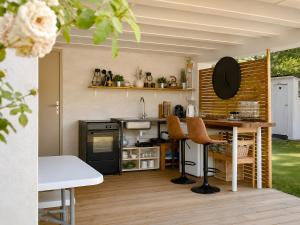 a kitchen with a sink and a counter with chairs at Studio "Bulle de Sainte-Baume" in Plan dʼAups +11 photos