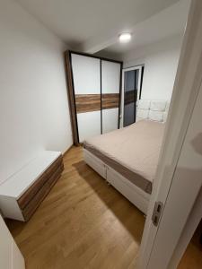 a small bedroom with a bed and a window at Božur 2 in Vrnjci