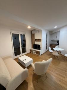 a living room with a couch and chairs and a table at Božur 2 in Vrnjci