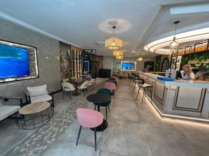 a restaurant with a bar with chairs and a counter at First Flatotel International in Benalmádena