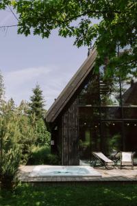 a glass house with a pool in the yard at Slow Tatry Boutique Resort&SPA in Zakopane +76 photos