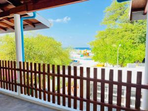 a wooden fence with a beach in the background at Sevenseas Seaview Maldives in Feridhoo