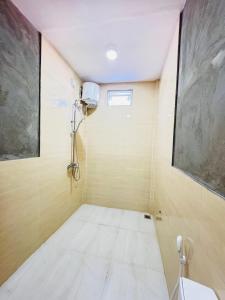 a small room with a shower in the ceiling at Sevenseas Seaview Maldives in Feridhoo +9 photos