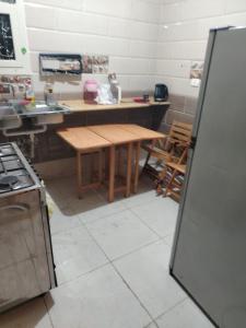 a kitchen with a wooden table and a refrigerator at العبور الحى التاسع in Obour