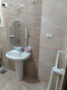 a bathroom with a sink and a mirror at العبور الحى التاسع in Obour +3 photos