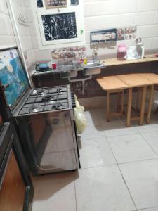 a kitchen with a stove top oven in a room at العبور الحى التاسع in Obour