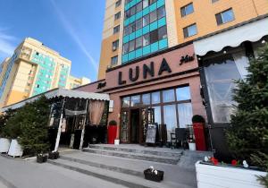 a luna store with stairs in front of a building at Luna Hotel Astana in Astana