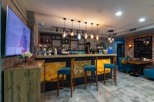 a bar in a restaurant with blue stools at Luna Hotel Astana in Astana +38 photos