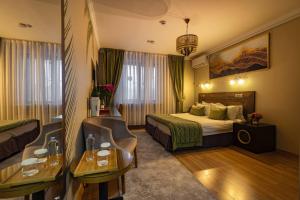 a hotel room with a bed and a desk at Luna Hotel Astana in Astana