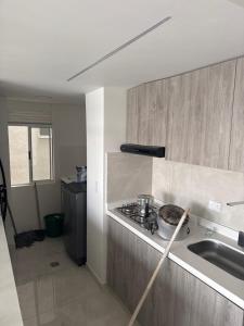 a kitchen with a stove with a pan on the counter at Apto en el sur de cali in Cali