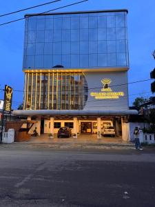 a building with cars parked in front of it at Hotel Golden Heights International in Ernakulam