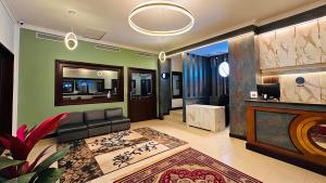 a living room with a couch and a table at Hotel Golden Heights International in Ernakulam