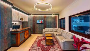 a living room with a couch and a tv at Hotel Golden Heights International in Ernakulam