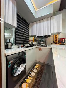 a kitchen with a dishwasher with food inside of it at Didi's Apartment in Lekki +13 photos