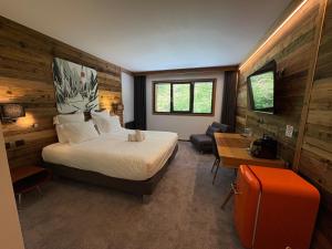 a hotel room with a bed and a desk and a room with a bed sidx at Chalet Marano Restaurant & Spa in Isola 2000 +116 photos