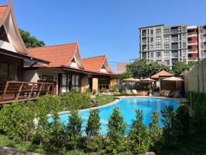 a swimming pool in front of a building at Flow Hua Hin - Ice Bath and Villa in Hua Hin